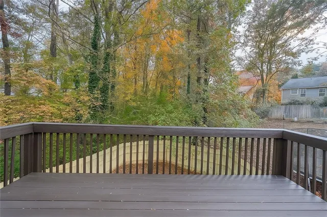 a view of a roof with wooden fence and floor