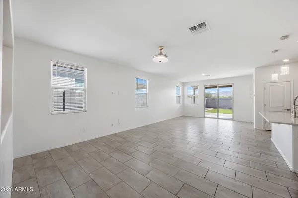 a view of empty room with wooden floor and window