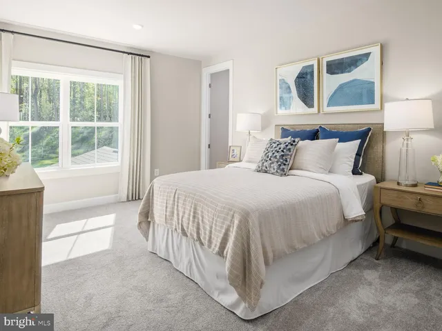 a bed sitting in a bedroom next to a window