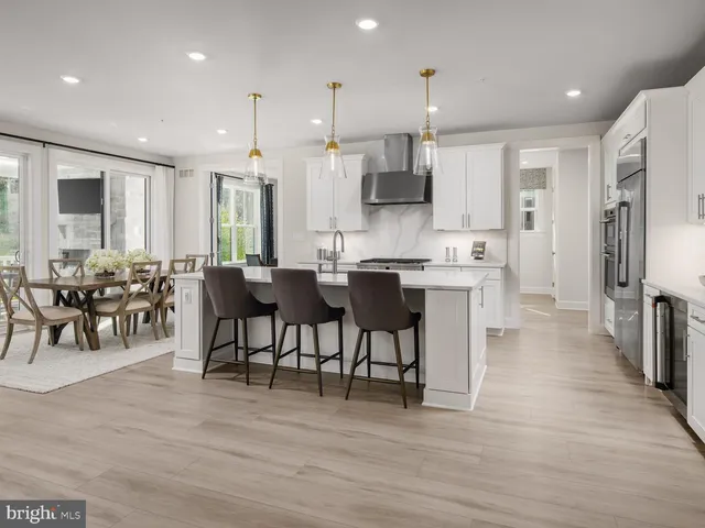 a large kitchen with a table and chairs