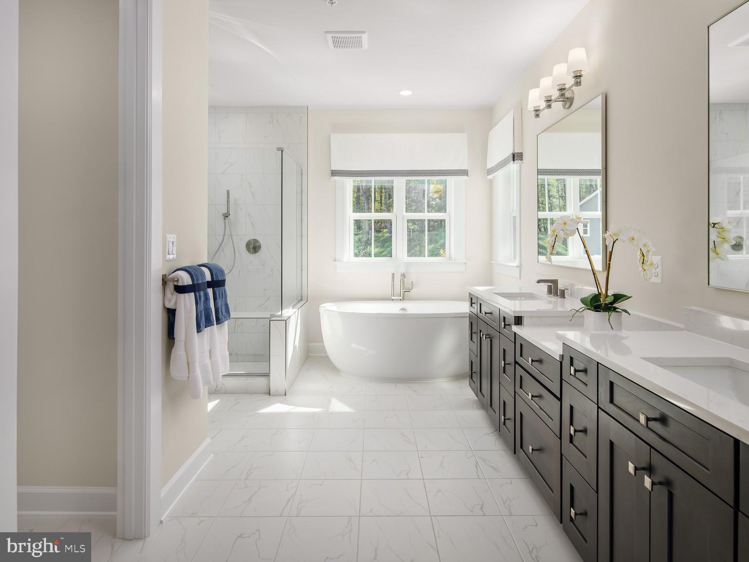 1222 Bear Branch Road Laurel, MD 20708 - Photo 9 of 17 a spacious bathroom with a double vanity sink a mirror and a bathtub