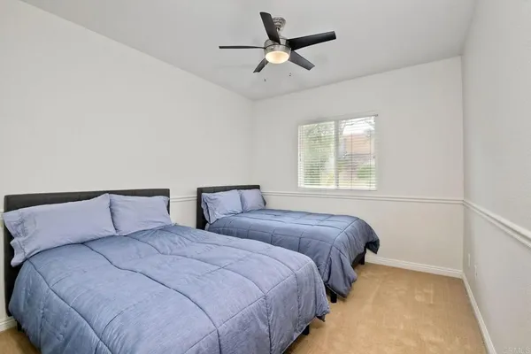 a bedroom with beds and a window