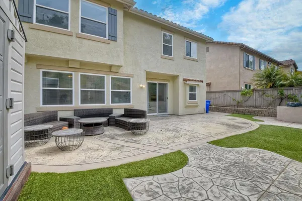a view of a house with backyard porch and sitting area