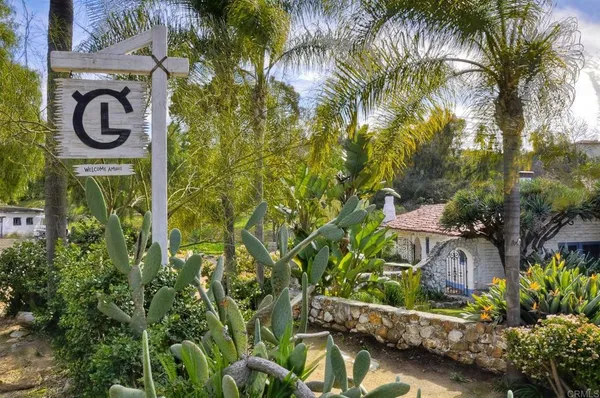 a sign that is in front of flowers