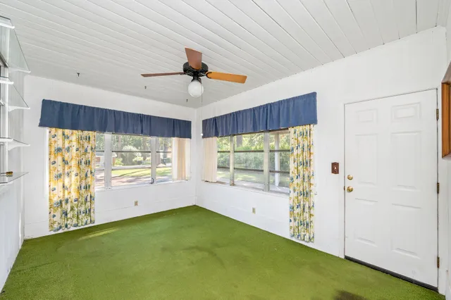 a view of room with window and a ceiling fan