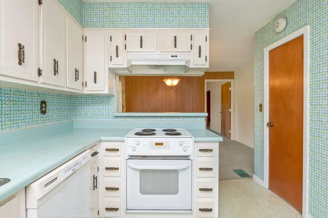 a kitchen with a sink a stove and cabinets