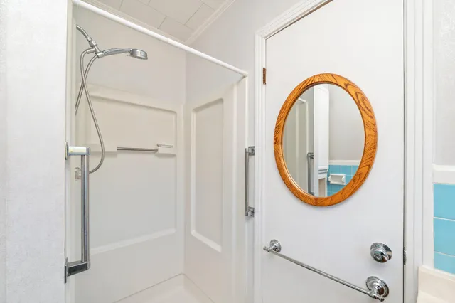 a bathroom with a mirror and a shower