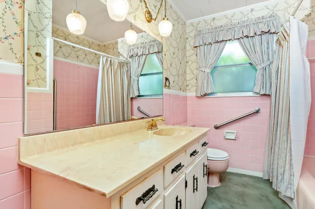 a bathroom with a sink mirror and vanity