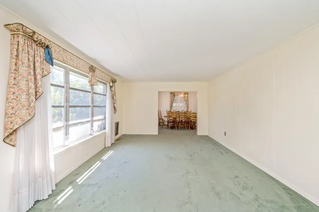 a view of an empty room and a window