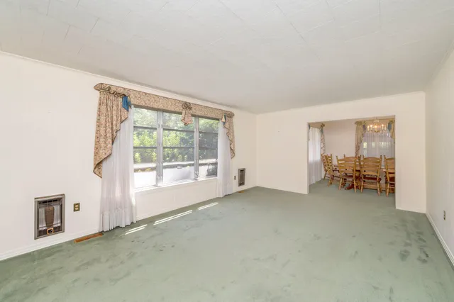 a view of a livingroom with a large window and couch