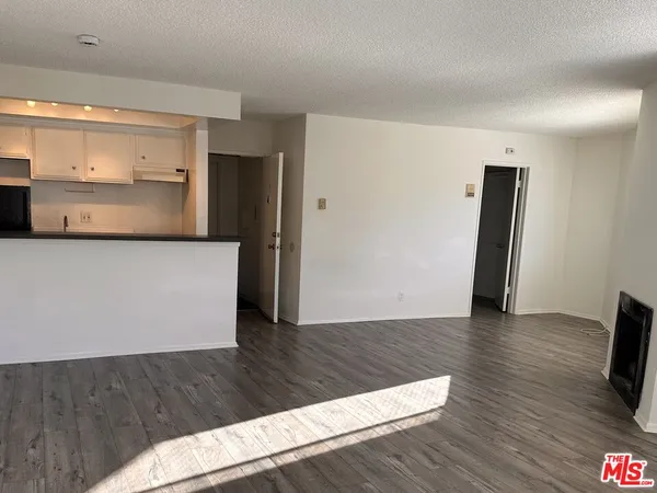 a view of a kitchen cabinets and wooden floor