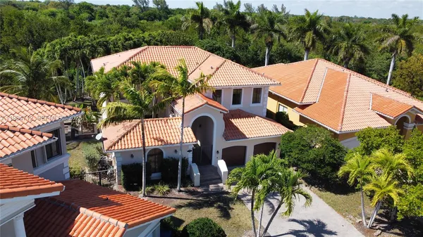 an aerial view of a house with a yard and sitting area