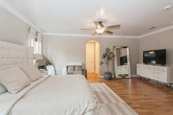a spacious bedroom with a large bed and a flat screen tv