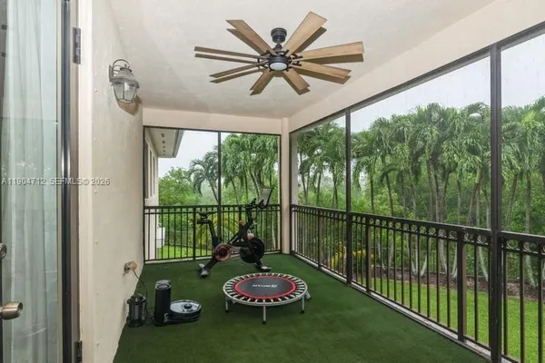 a view of a porch with furniture and hardwood floor