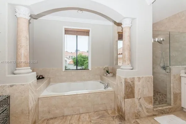 a bathroom with a bathtub and shower