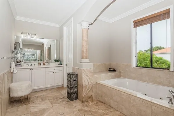 a bathroom with a granite countertop sink mirror and a bathtub