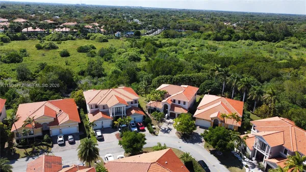 an aerial view of house with swimming pool residential house and green space