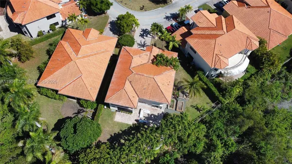 an aerial view of a house with backyard and outdoor seating