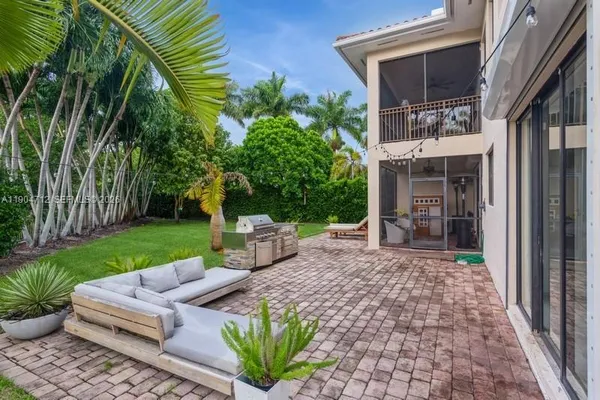 a view of a house with backyard and sitting area