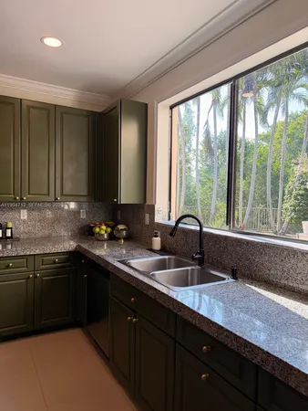 a kitchen with a sink and a stove top oven