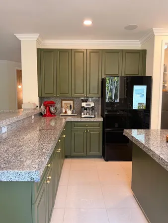 a kitchen with sink a window and cabinets