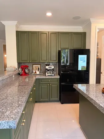 a kitchen with granite countertop a stove top oven and cabinets