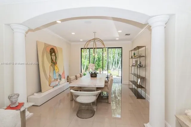 a dining room with furniture and a floor to ceiling window