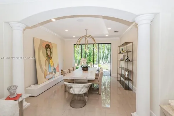 a large white room with a large window and furniture