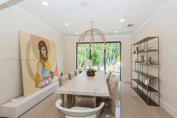 a dining room with furniture and a floor to ceiling window
