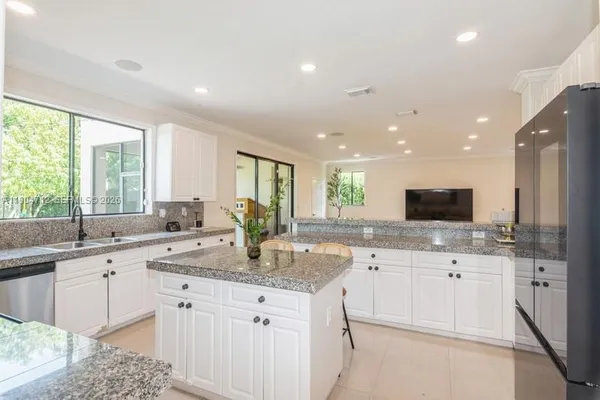 a view of a kitchen counter space a sink and appliances