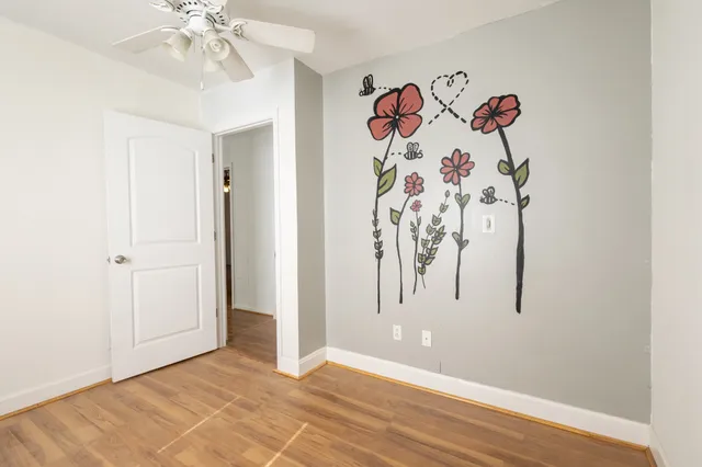 a view of a room with a painting on the wall