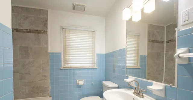 a bathroom with a toilet sink and shower