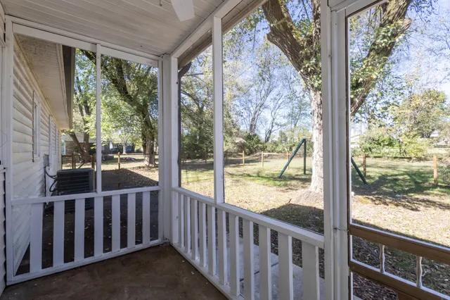 a view of a room with wooden floor and wooden fence