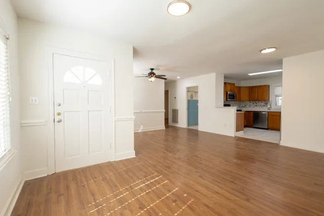 a view of a kitchen with a sink and a refrigerator