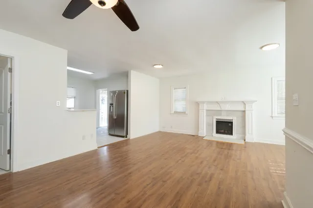 wooden floor in an empty room with a fireplace