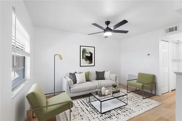 a living room with furniture a rug and a window