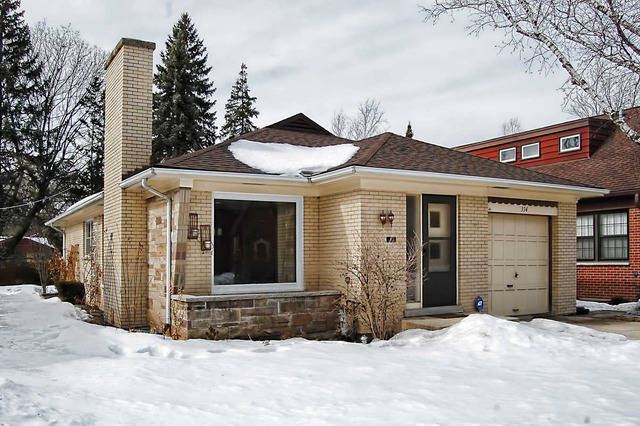 a view of a house with a yard and garage