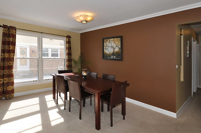 334 Stratford Road Des Plaines, IL 60016 - Photo 6 of 16 a view of a dining room with furniture and a large window