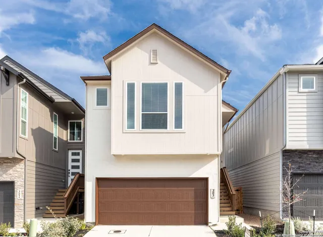 a front view of a house with garage