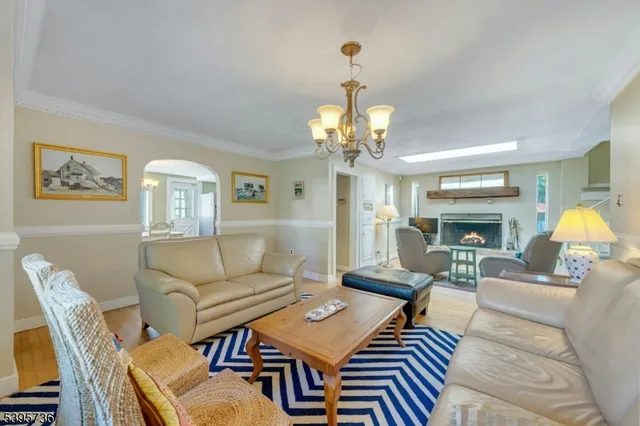 a view of a dining room with furniture and chandelier