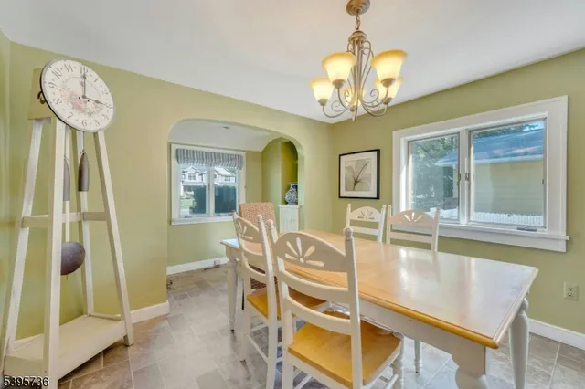 a view of a dining room with furniture and a chandelier