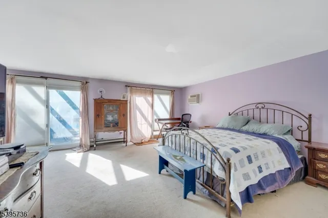 a bathroom with a tub a shower and a window