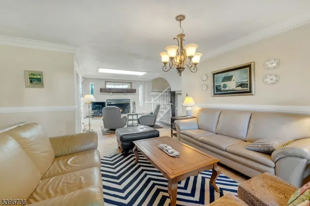 a living room with furniture and a chandelier