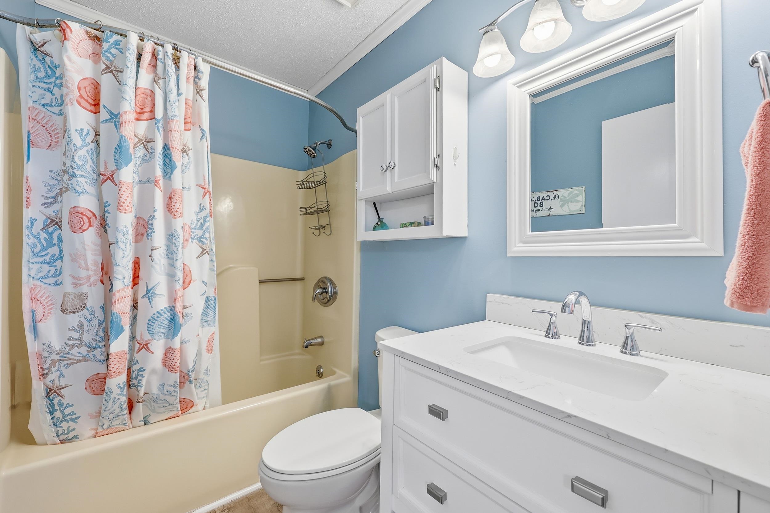 2001 Spring Street, Unit H2 North Myrtle Beach, SC 29582 - Photo 16 of 25 Full bathroom with shower / tub combo, vanity, a textured ceiling, and ornamental molding