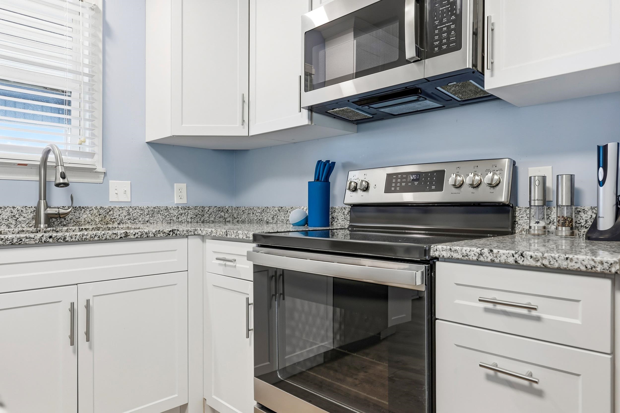2001 Spring Street, Unit H2 North Myrtle Beach, SC 29582 - Photo 5 of 25 Kitchen featuring stainless steel appliances, white cabinetry, and light stone counters