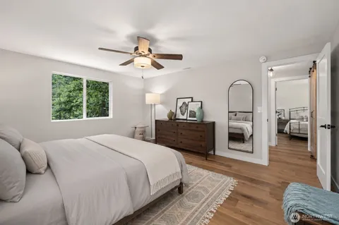 a spacious bedroom with a bed a couch and a window