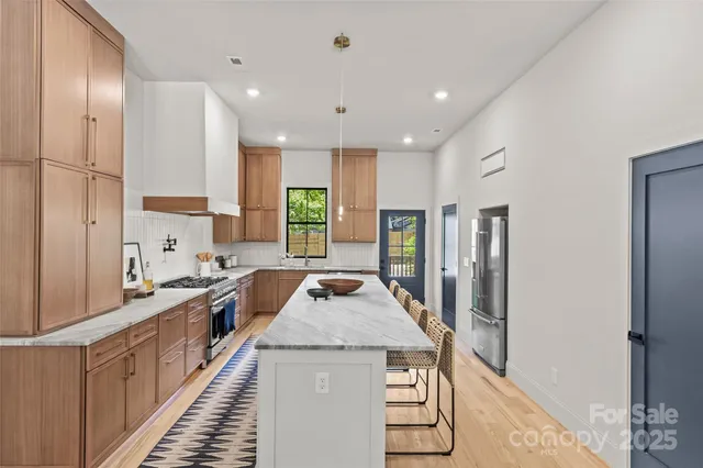 a kitchen with stainless steel appliances granite countertop a stove and a refrigerator