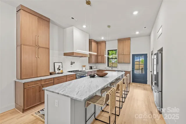 a kitchen with a stove a sink and a refrigerator