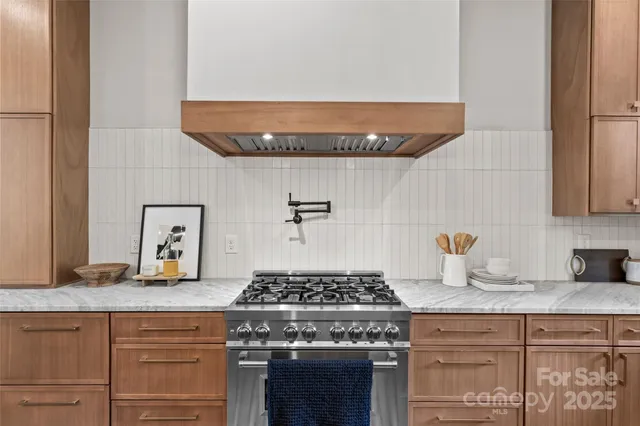 a stove top oven sitting inside of a kitchen