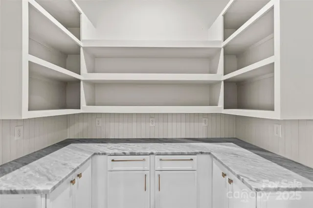 a stove top oven sitting inside of a kitchen